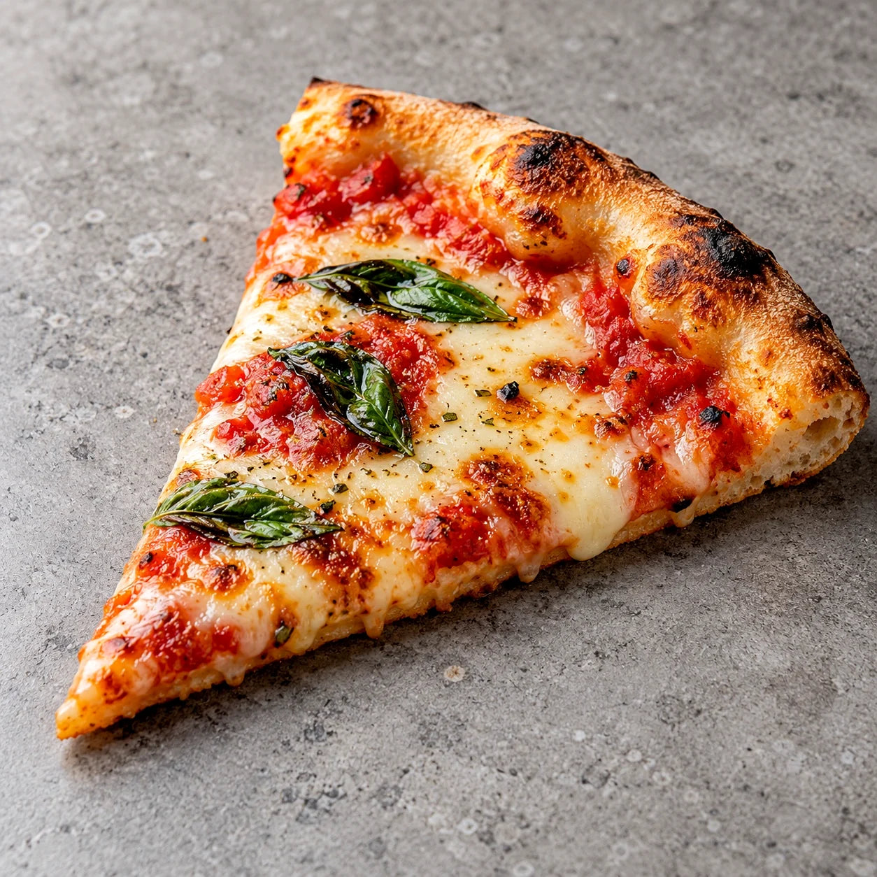 Cheesy tomato pizza slice with basil